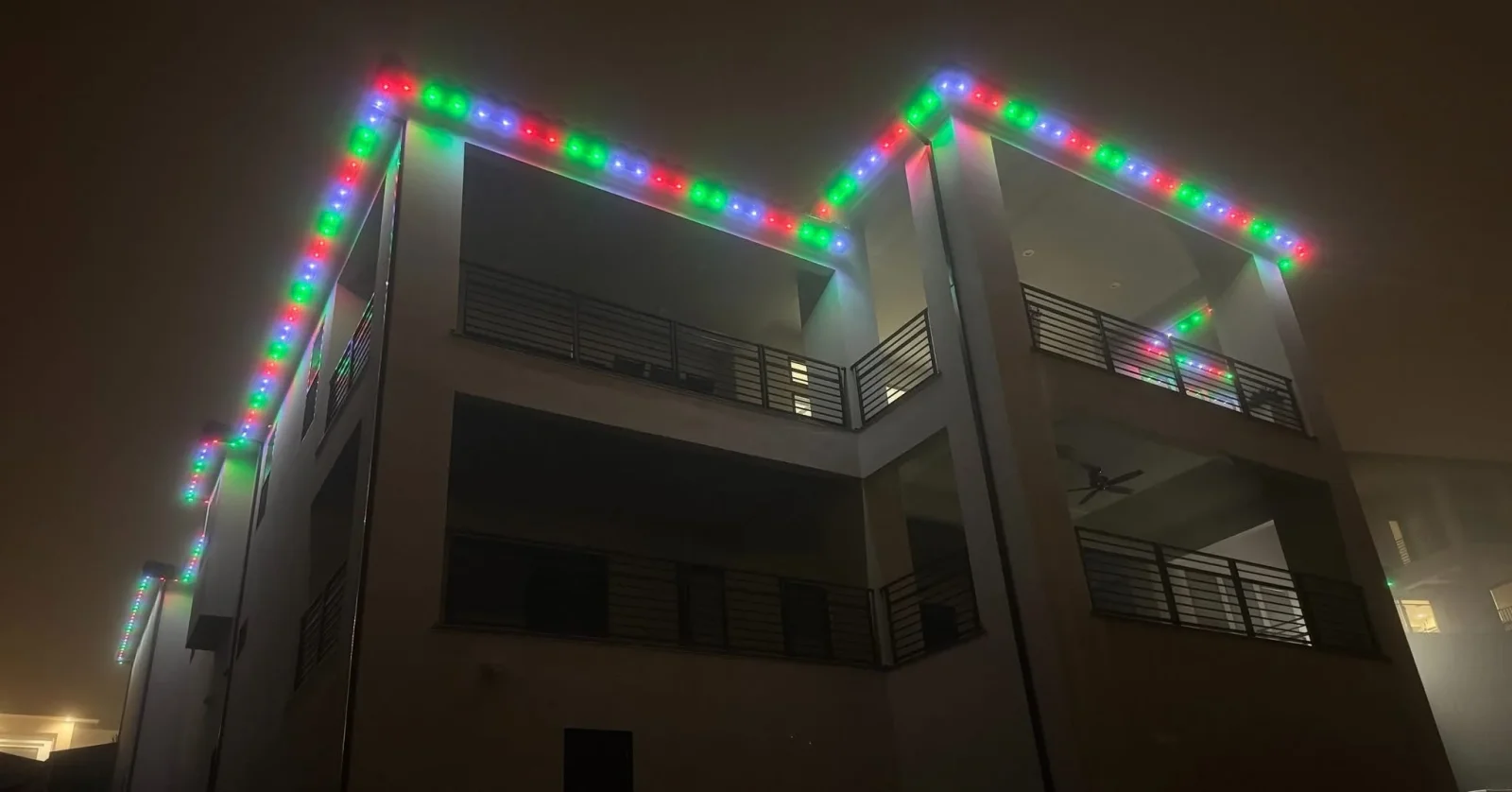 RGB LED strip lighting installed on building roofline and edges with red, green, and blue illumination