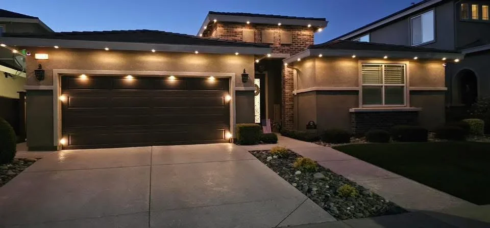 LED recessed and accent lighting on modern home exterior, garage door, and soffit